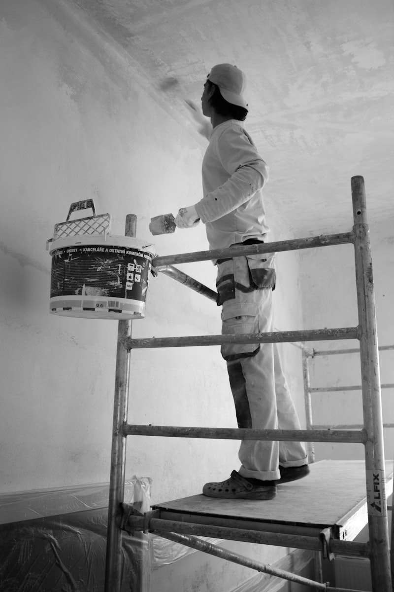 Decorator painting a wall with a roller