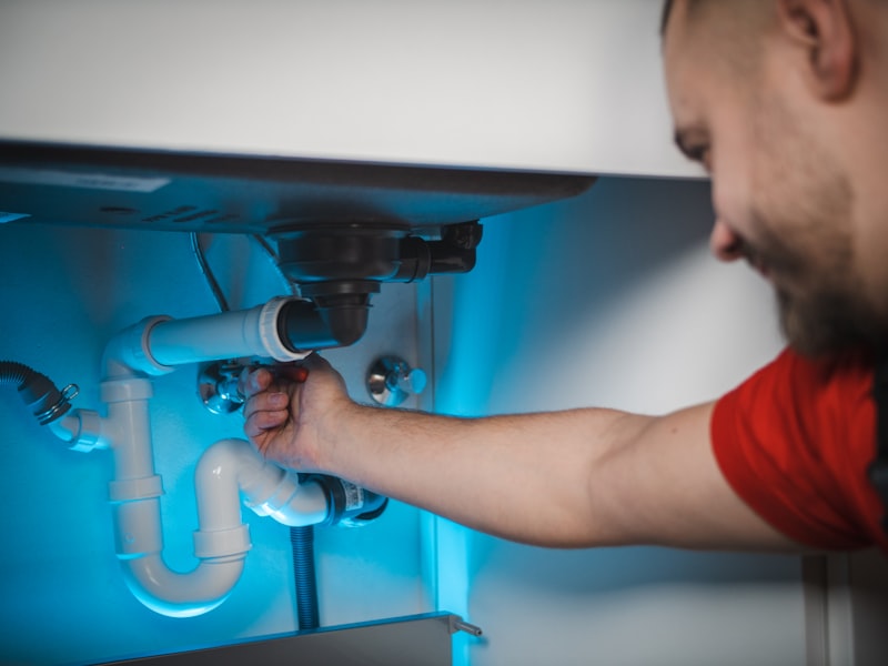 Plumber repairing pipework